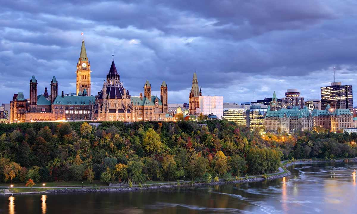 Ottawa skyline at dusk with Parliament Hill and the Ottawa River